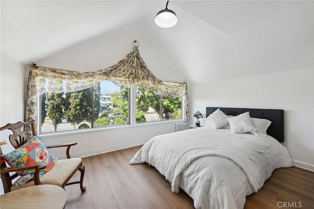 318 E 11th St, Pomona, CA 91766 - bedroom featuring vaulted ceiling, wood finished floors, and baseboards