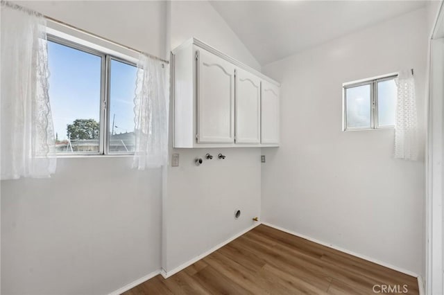 318 E 11th St, Pomona, CA 91766 - laundry room featuring cabinet space, wood finished floors, baseboards, and washer hookup