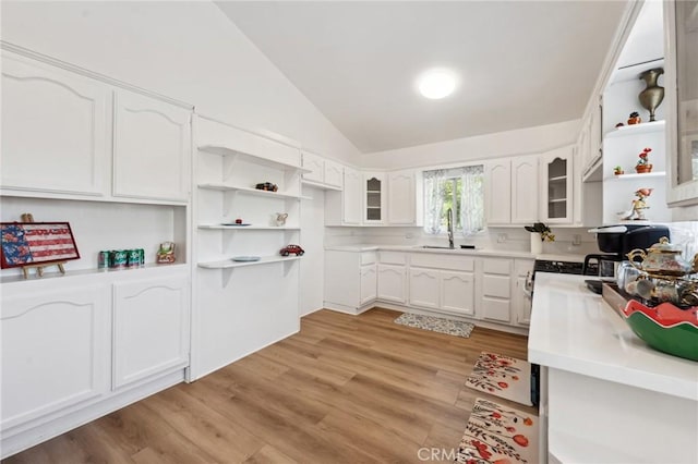 318 E 11th St, Pomona, CA 91766 - kitchen with open shelves, vaulted ceiling, a sink, and white cabinetry