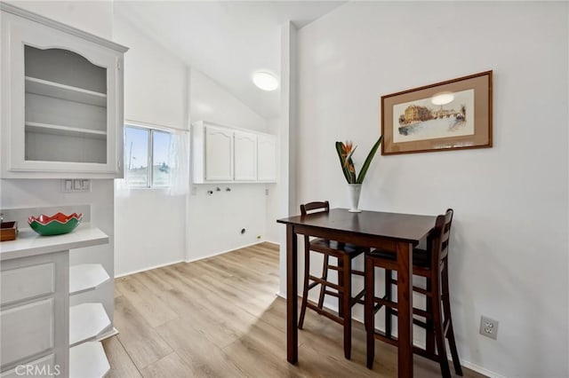 318 E 11th St, Pomona, CA 91766 - dining space featuring light wood finished floors and lofted ceiling