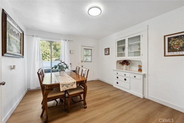 318 E 11th St, Pomona, CA 91766 - dining area featuring baseboards and light wood-style floors