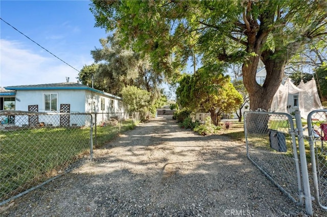 318 E 11th St, Pomona, CA 91766 - view of street featuring driveway and a gated entry