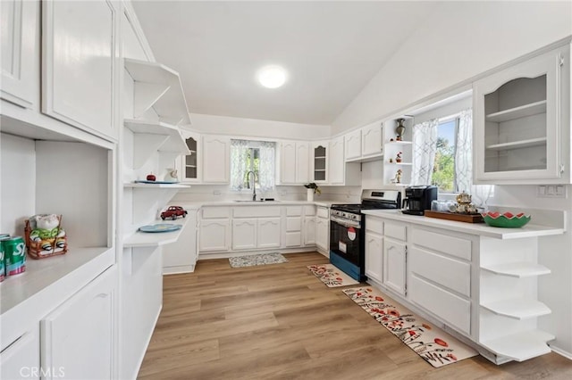 318 E 11th St, Pomona, CA 91766 - kitchen with open shelves, a sink, white cabinetry, lofted ceiling, and stainless steel range with gas stovetop