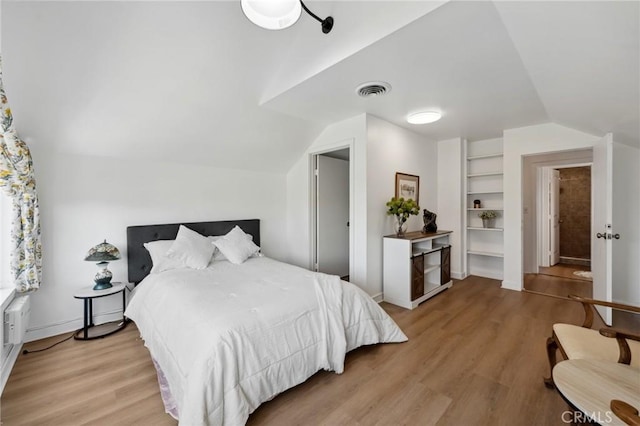 318 E 11th St, Pomona, CA 91766 - bedroom featuring vaulted ceiling, light wood-style floors, visible vents, and baseboards