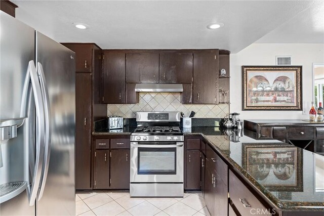 kitchen featuring dark brown cabinetry, backsplash, appliances with stainless steel finishes, visible vents, and ventilation hood