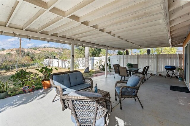 view of patio / terrace with an outdoor living space, a fenced backyard, and outdoor dining space