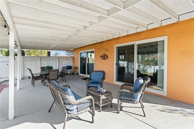view of patio / terrace featuring fence and outdoor dining area