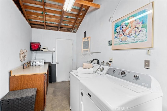 laundry room with a towering ceiling, washer and clothes dryer, and laundry area