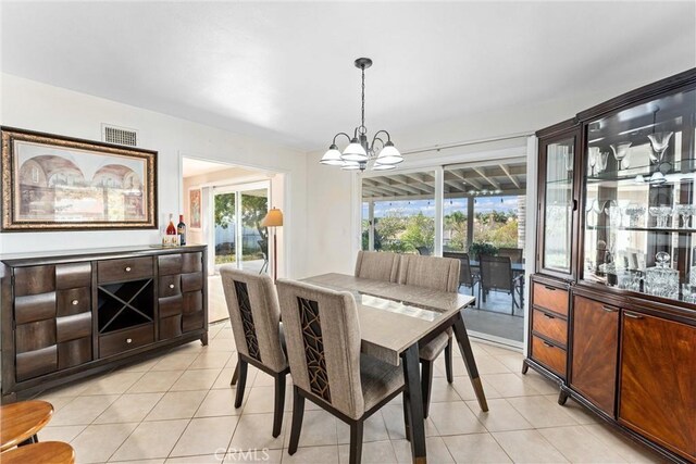 dining area with visible vents, a chandelier, and light tile patterned flooring