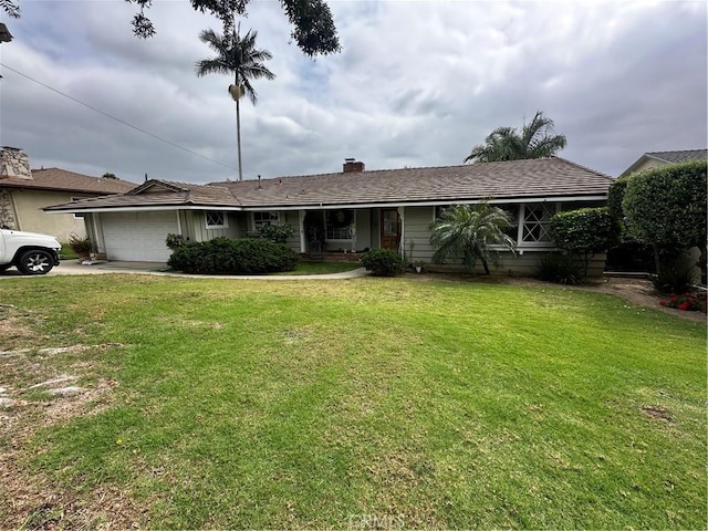 single story home featuring concrete driveway, an attached garage, a chimney, and a front yard