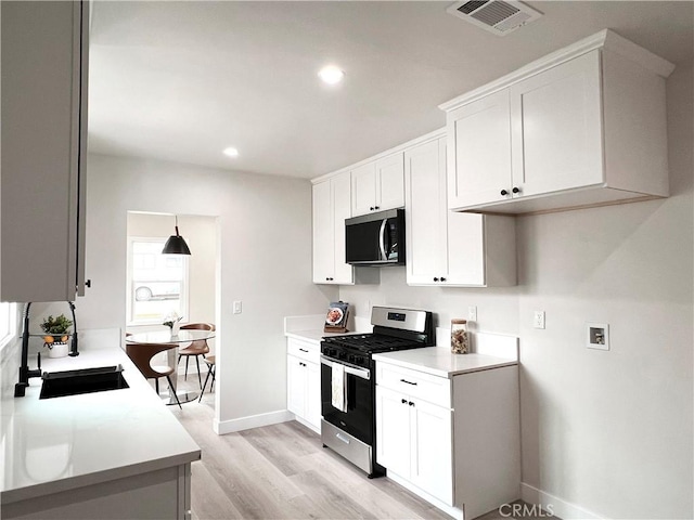 834 Morada Pl, Altadena, CA 91001 - kitchen with light countertops, visible vents, light wood-type flooring, baseboards, and appliances with stainless steel finishes