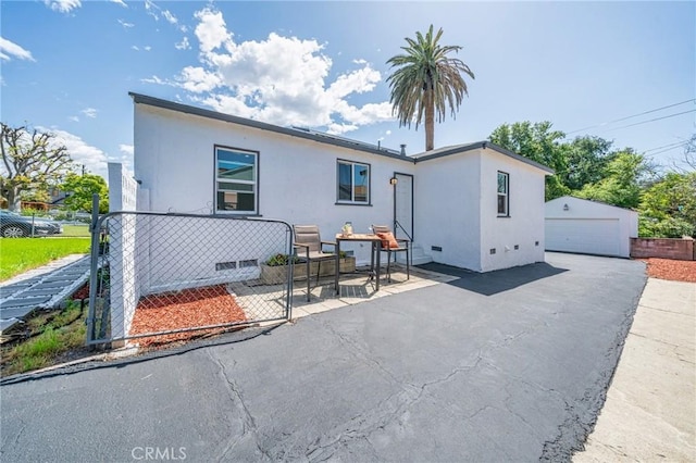 834 Morada Pl, Altadena, CA 91001 - back of house with fence, an outdoor structure, stucco siding, and a garage