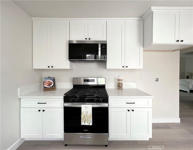 834 Morada Pl, Altadena, CA 91001 - kitchen featuring baseboards, appliances with stainless steel finishes, light wood-style floors, and light countertops