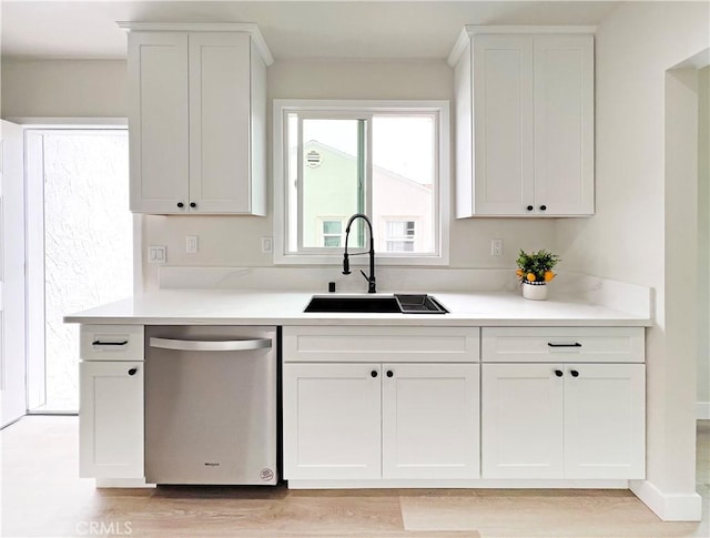 834 Morada Pl, Altadena, CA 91001 - kitchen featuring stainless steel dishwasher, a sink, light wood-type flooring, light countertops, and white cabinets