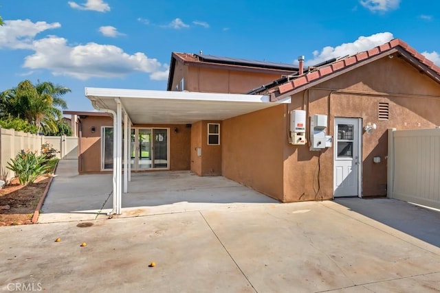 44863 Rein Ct, Temecula, CA 92592 - view of front facade with stucco siding, a carport, and roof mounted solar panels