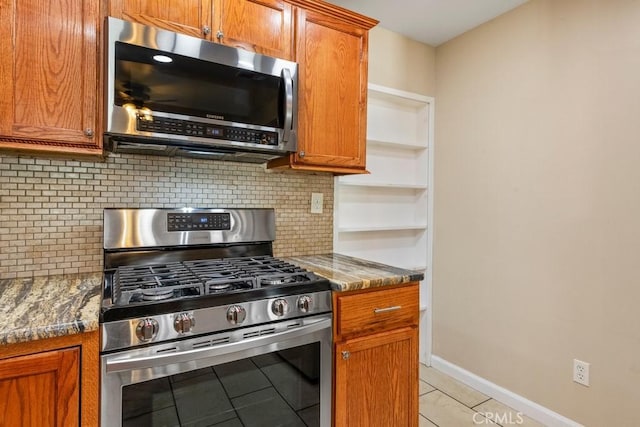 44863 Rein Ct, Temecula, CA 92592 - kitchen featuring appliances with stainless steel finishes, tasteful backsplash, brown cabinets, and stone counters