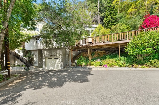 2402 Aspen Dr, Los Angeles, CA 90068 - view of front of house with an attached garage, aphalt driveway, a wooden deck, and stairs