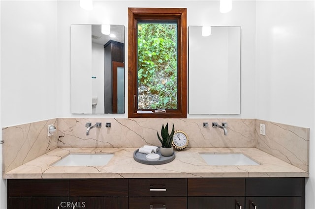 2402 Aspen Dr, Los Angeles, CA 90068 - bathroom featuring a sink, double vanity, and tasteful backsplash