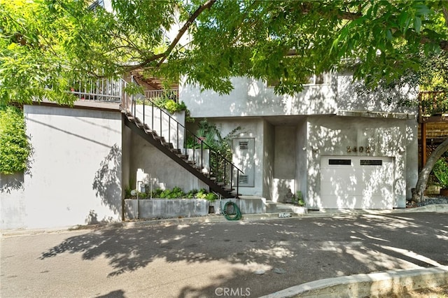 2402 Aspen Dr, Los Angeles, CA 90068 - view of front of property featuring stucco siding, stairway, and a garage