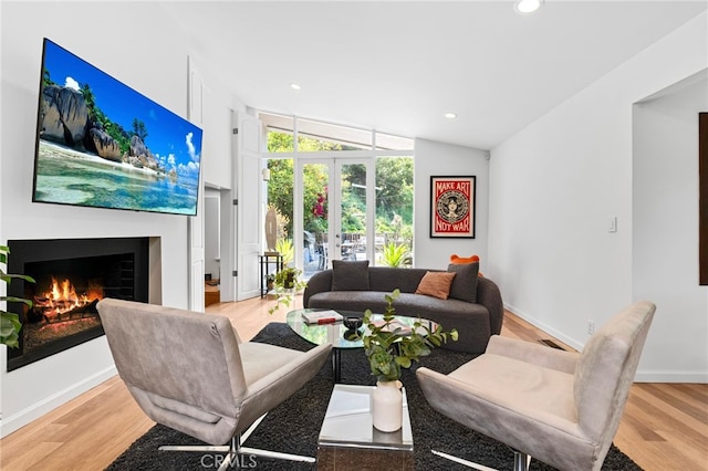 2402 Aspen Dr, Los Angeles, CA 90068 - living room with light wood-style flooring, recessed lighting, and a lit fireplace