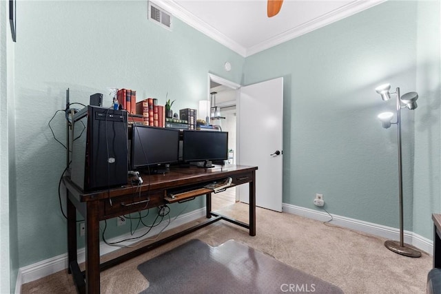 carpeted office with visible vents, crown molding, baseboards, and ceiling fan