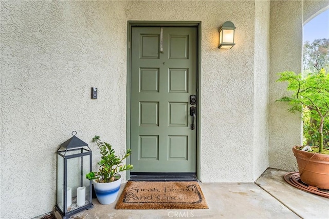 property entrance with stucco siding