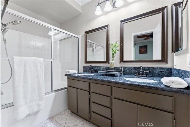 full bathroom with ceiling fan, a sink, shower / bath combination with glass door, and double vanity