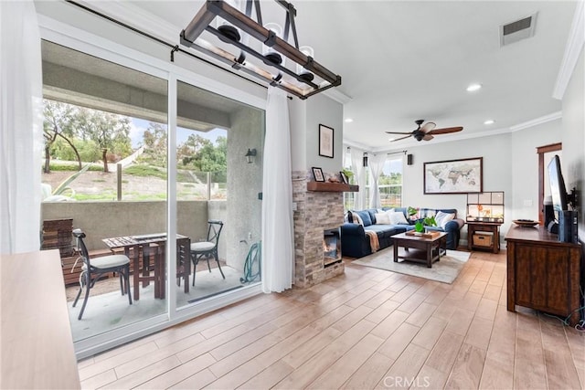 living area with recessed lighting, wood finished floors, visible vents, a ceiling fan, and crown molding