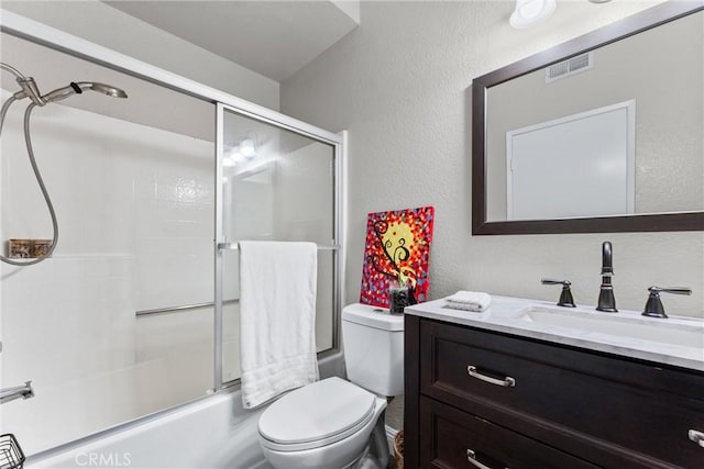 full bath with toilet, vanity, bath / shower combo with glass door, and visible vents