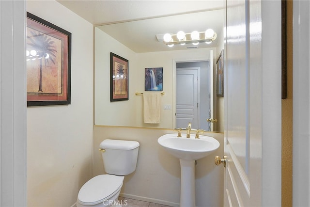 half bathroom featuring toilet
