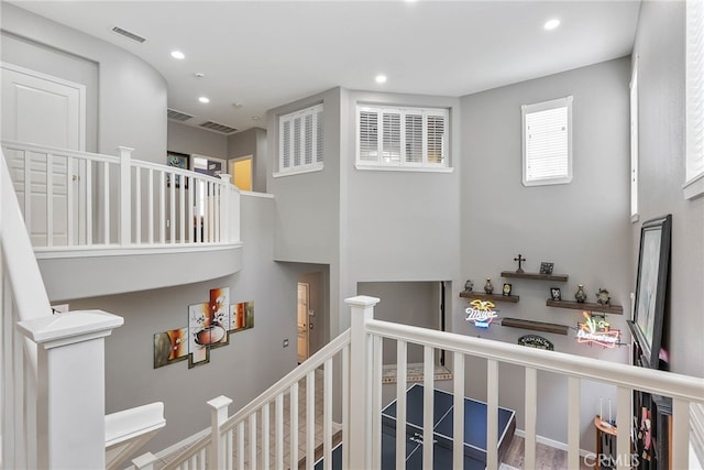 staircase with visible vents and recessed lighting