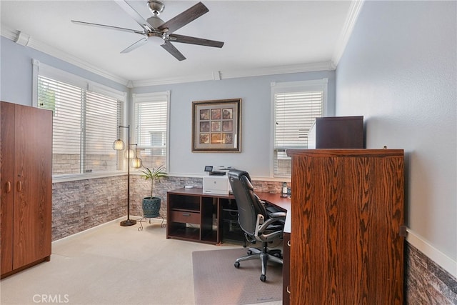 carpeted office with plenty of natural light, ornamental molding, and ceiling fan