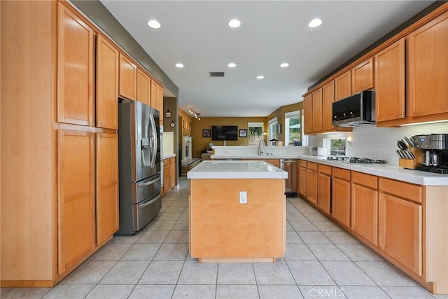 kitchen featuring light countertops, stainless steel appliances, recessed lighting, a peninsula, and visible vents
