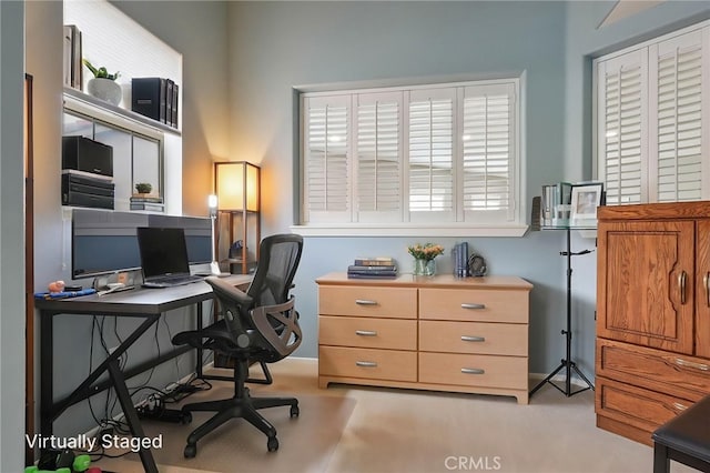 office featuring baseboards and a healthy amount of sunlight