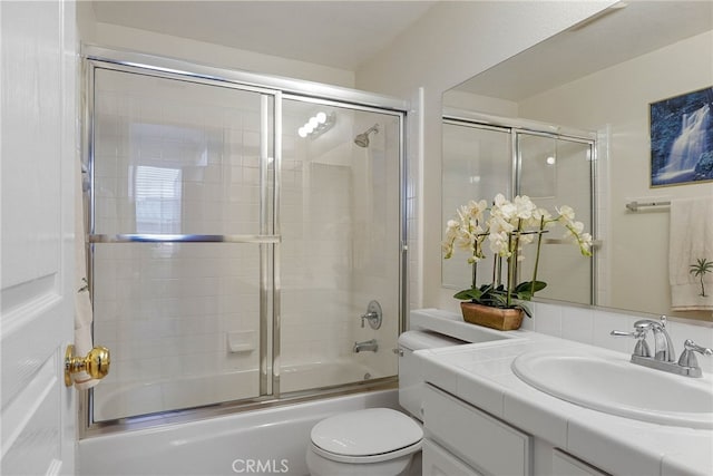 full bathroom featuring toilet, enclosed tub / shower combo, and vanity