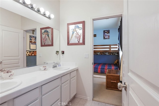 full bathroom with ensuite bathroom, a sink, and double vanity