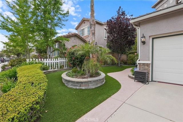 view of yard featuring a garage and fence