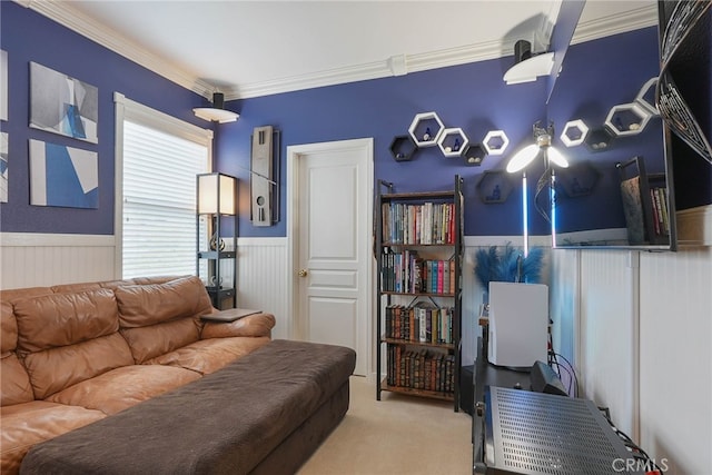 living area with ornamental molding, carpet, and wainscoting