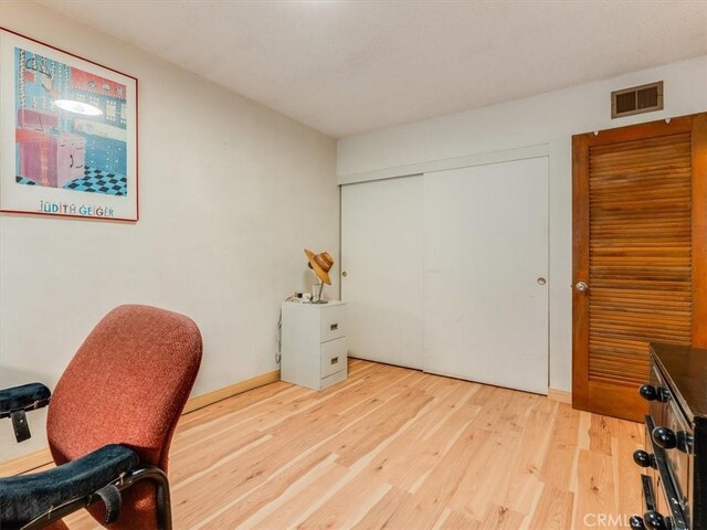 office featuring light wood-style flooring and visible vents