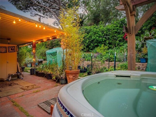 exterior space with a patio area and a hot tub