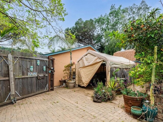 view of patio / terrace featuring a gate, a gazebo, and fence