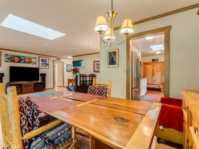 dining room featuring a skylight and ornamental molding