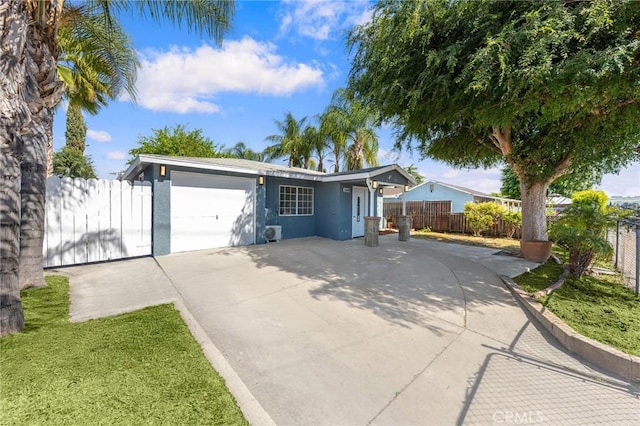 ranch-style home with an attached garage, driveway, fence, and stucco siding
