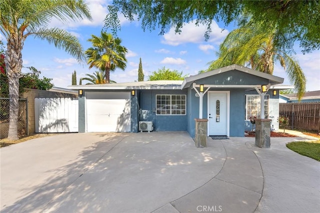 single story home featuring concrete driveway, fence, a garage, ac unit, and stucco siding