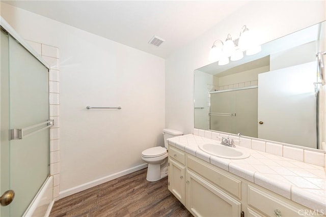 51192 Bon Veu Dr, Oakhurst, CA 93644 - bathroom with wood finished floors, vanity, and bath / shower combo with glass door