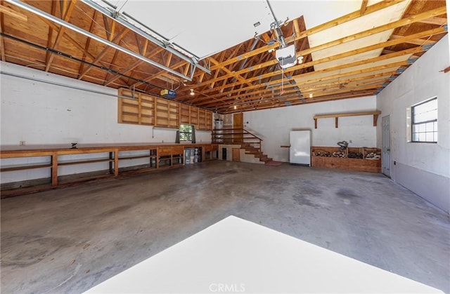 51192 Bon Veu Dr, Oakhurst, CA 93644 - garage featuring freestanding refrigerator and a garage door opener