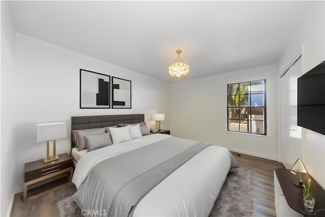 51192 Bon Veu Dr, Oakhurst, CA 93644 - bedroom with wood finished floors and a chandelier
