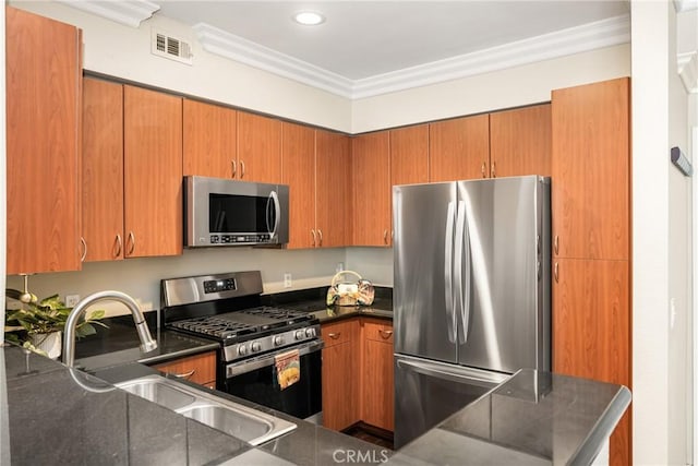 kitchen featuring appliances with stainless steel finishes, crown molding, a sink, brown cabinets, and recessed lighting