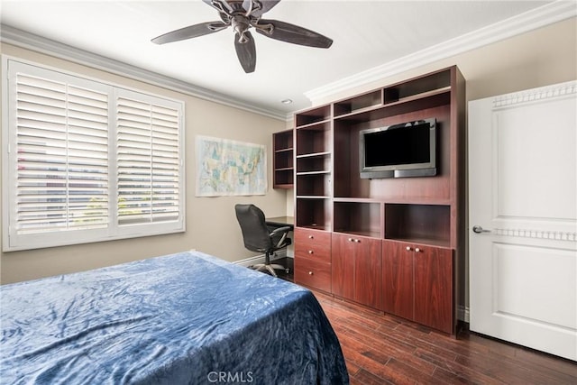 bedroom featuring crown molding, dark wood-type flooring, ceiling fan, and a desk