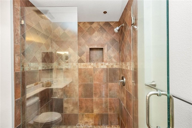 full bath with a shower stall and toilet